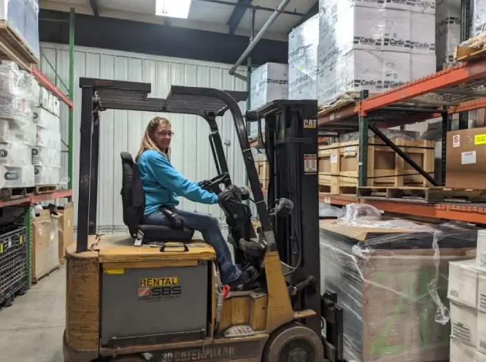 woman worker driving forklift