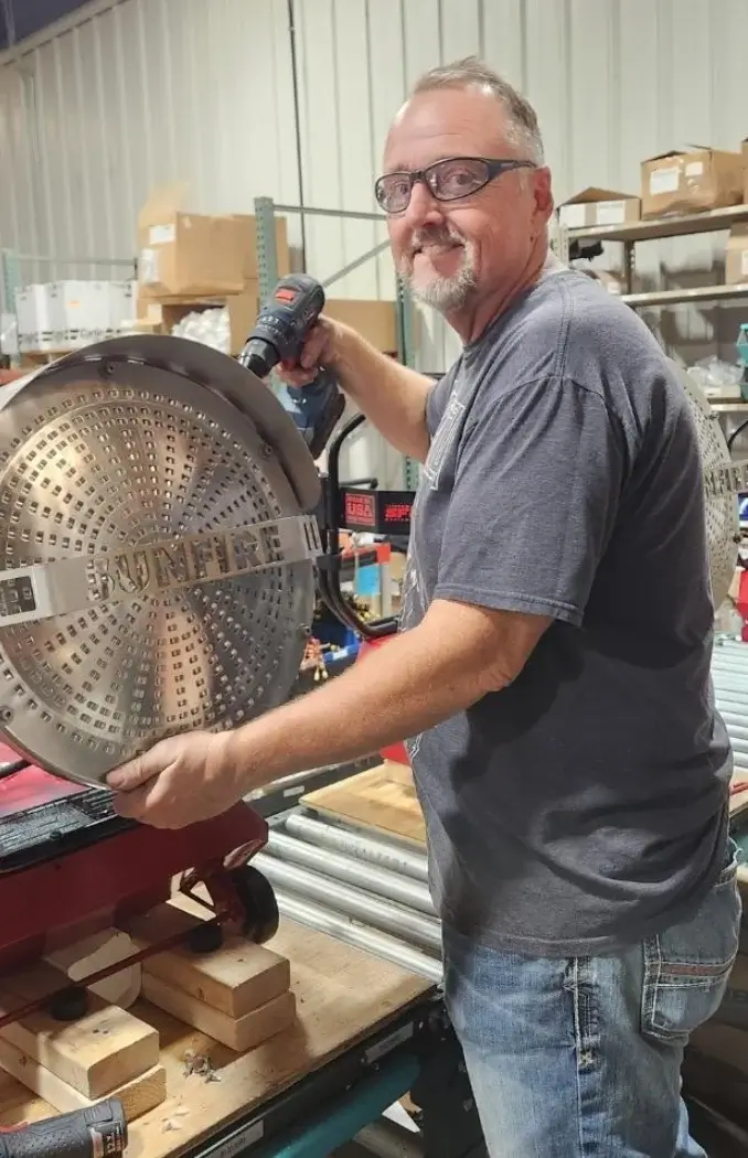 worker happy smiling holding metal and screwdriver